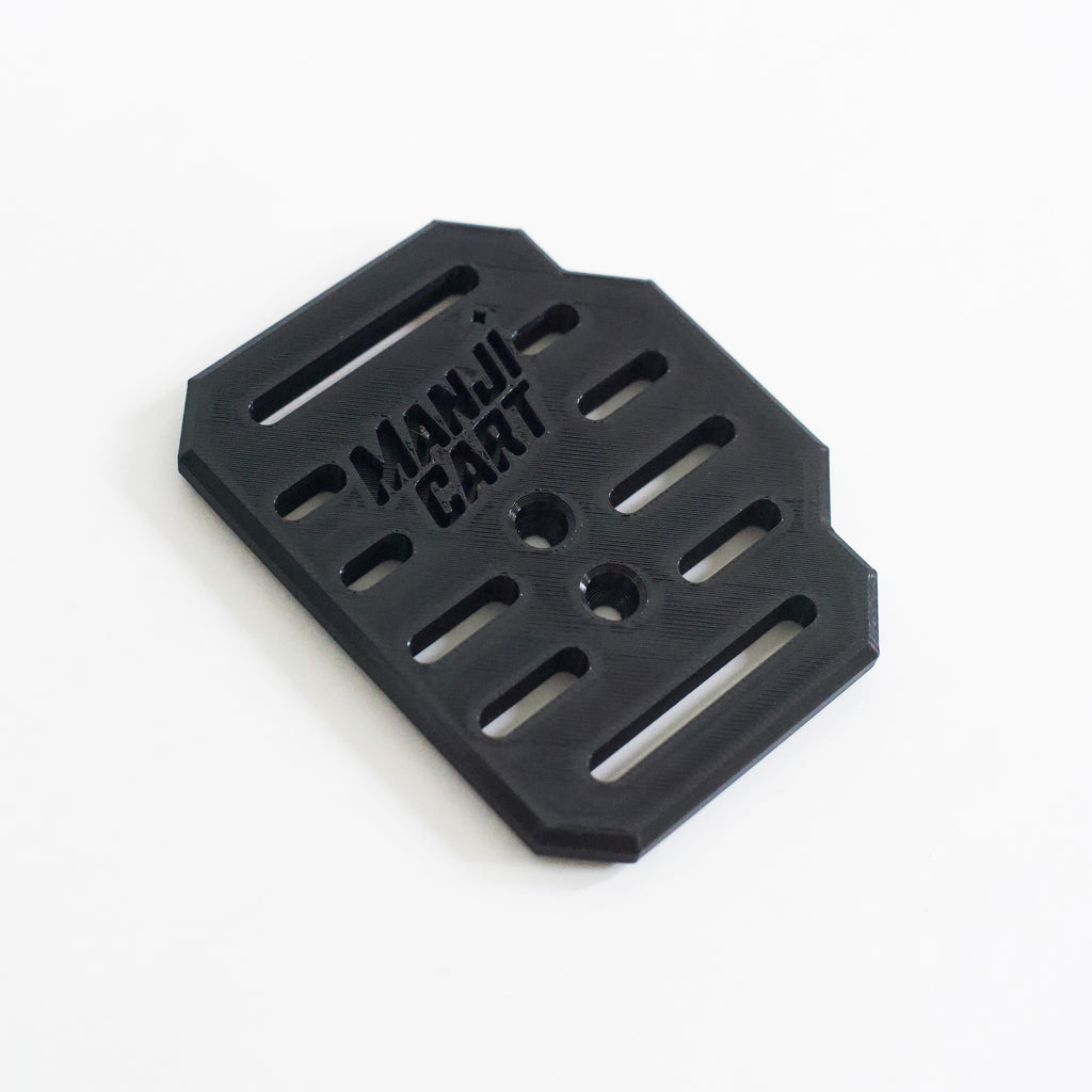 Close up side view of throttle pedal with Manji Cart branding.